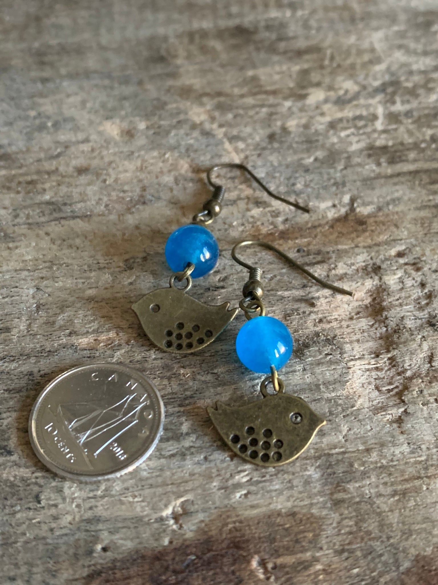 Boucles d’oreilles breloque oiseau bronze et bille de verre bleu Comme un ange